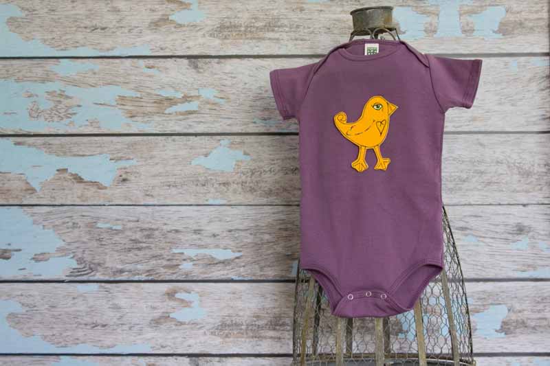 Goldenrod Bird on Eggplant organic Onesie